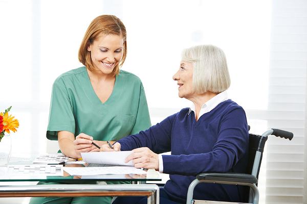 nurse helping elderly lady with dementia